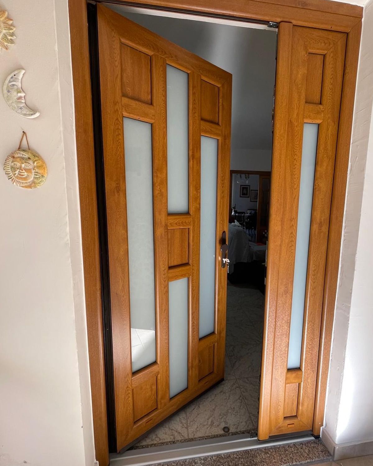 Una porta di legno è aperta su un soggiorno