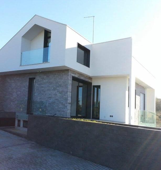 Una casa bianca con un balcone e un cielo azzurro sullo sfondo