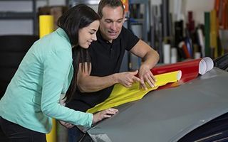 Car wrapping specialist consulting client about vinyl films - Vinyl Graphics in Clearwater, FL