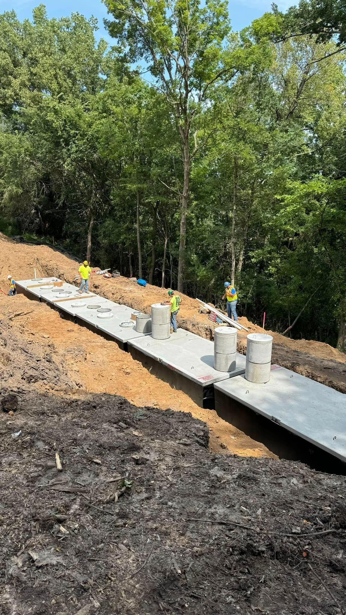 A concrete walkway is being built on top of a dirt hill.
