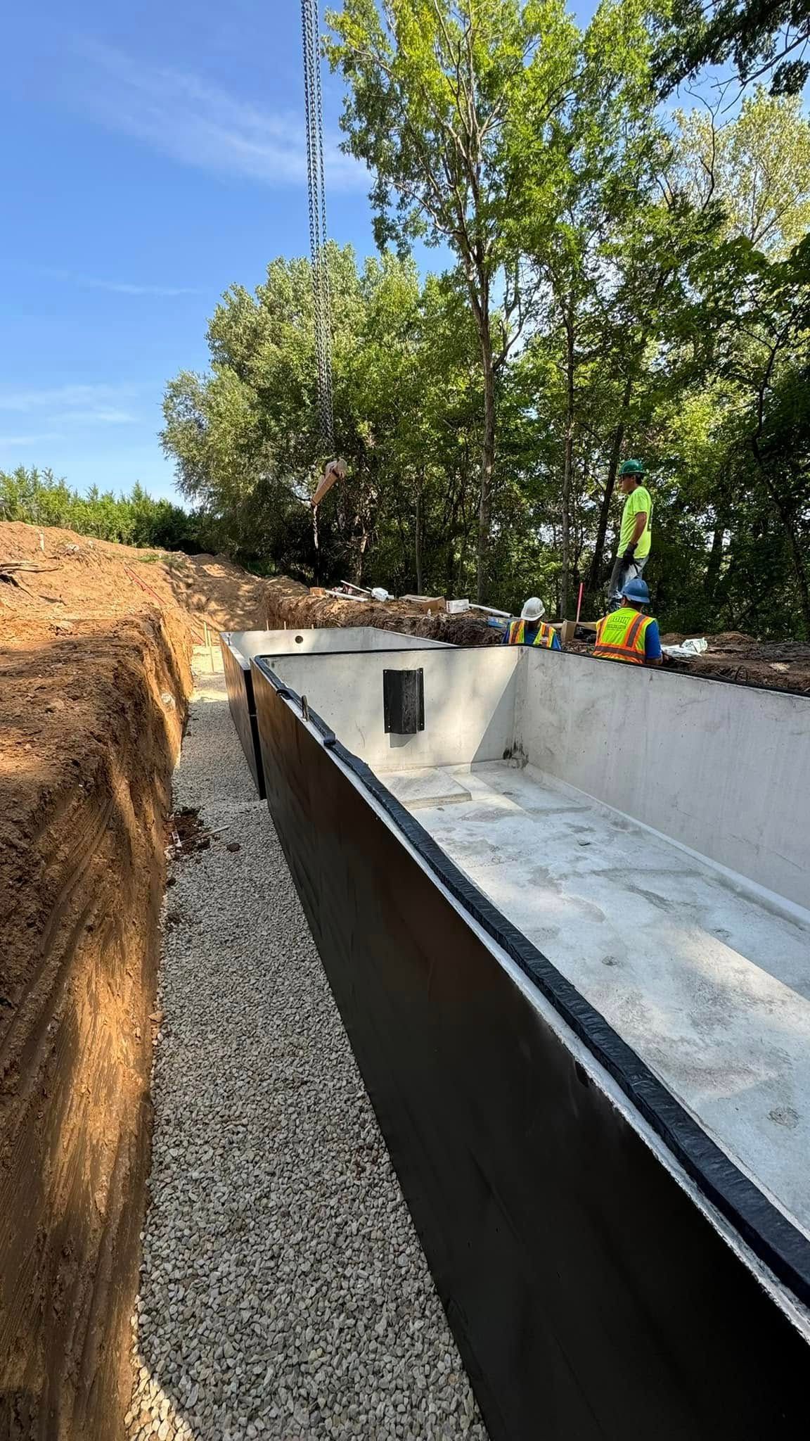 A swimming pool is being built in the woods.
