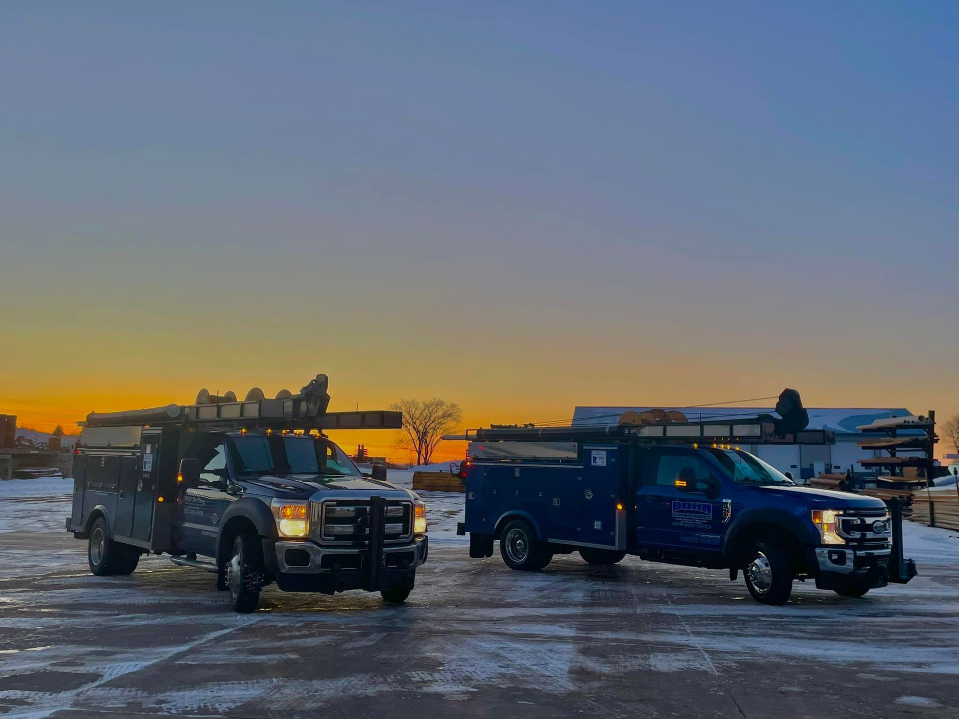 Two trucks are parked next to each other in a parking lot.