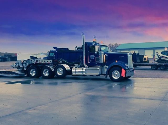 A blue semi truck is parked in a parking lot.