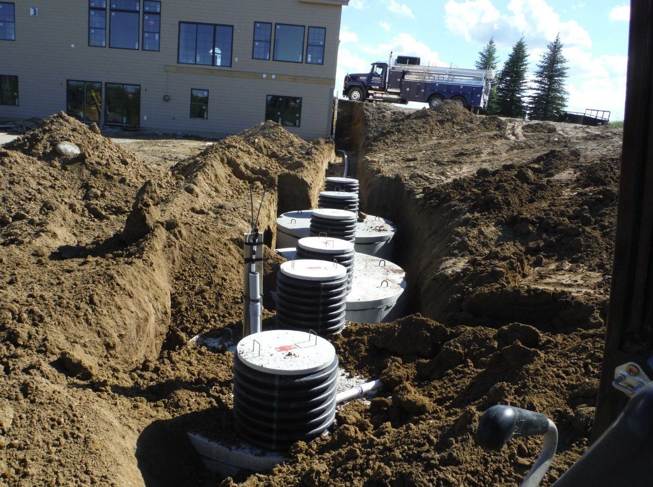 A large pile of dirt with a building in the background