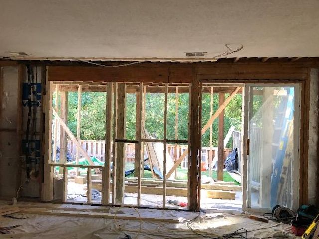 A room with a lot of windows and a sliding glass door.