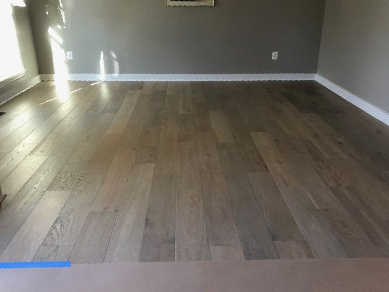 A living room with hardwood floors and gray walls.