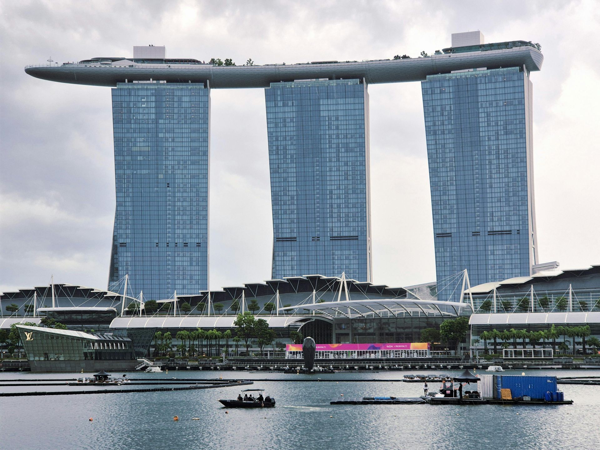 Marina Bay Sands hotel in Singapore, with three towers and a rooftop SkyPark, overlooking the water.
