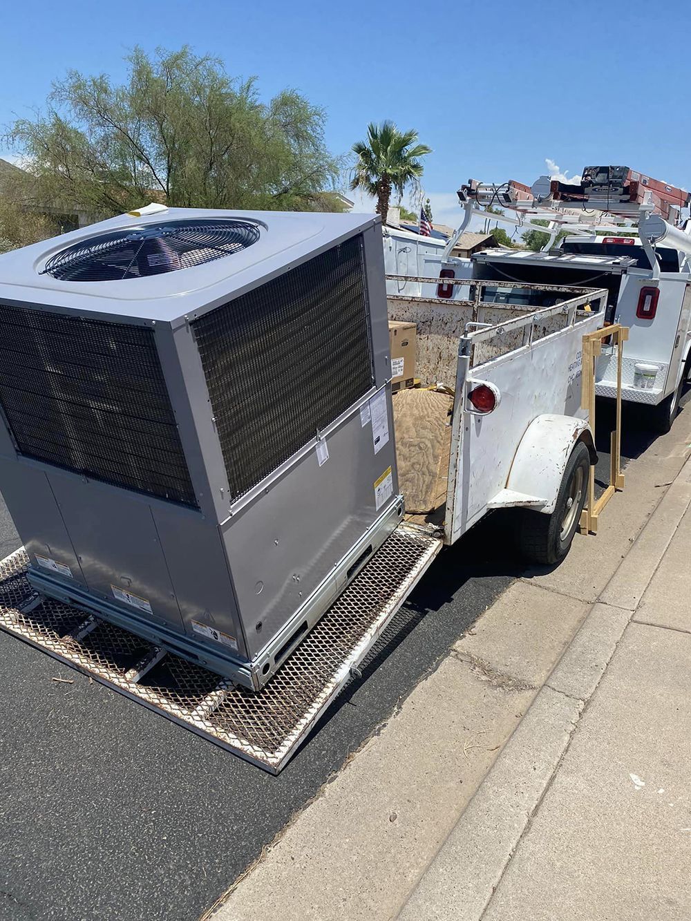 A large air conditioner is sitting on top of a trailer.