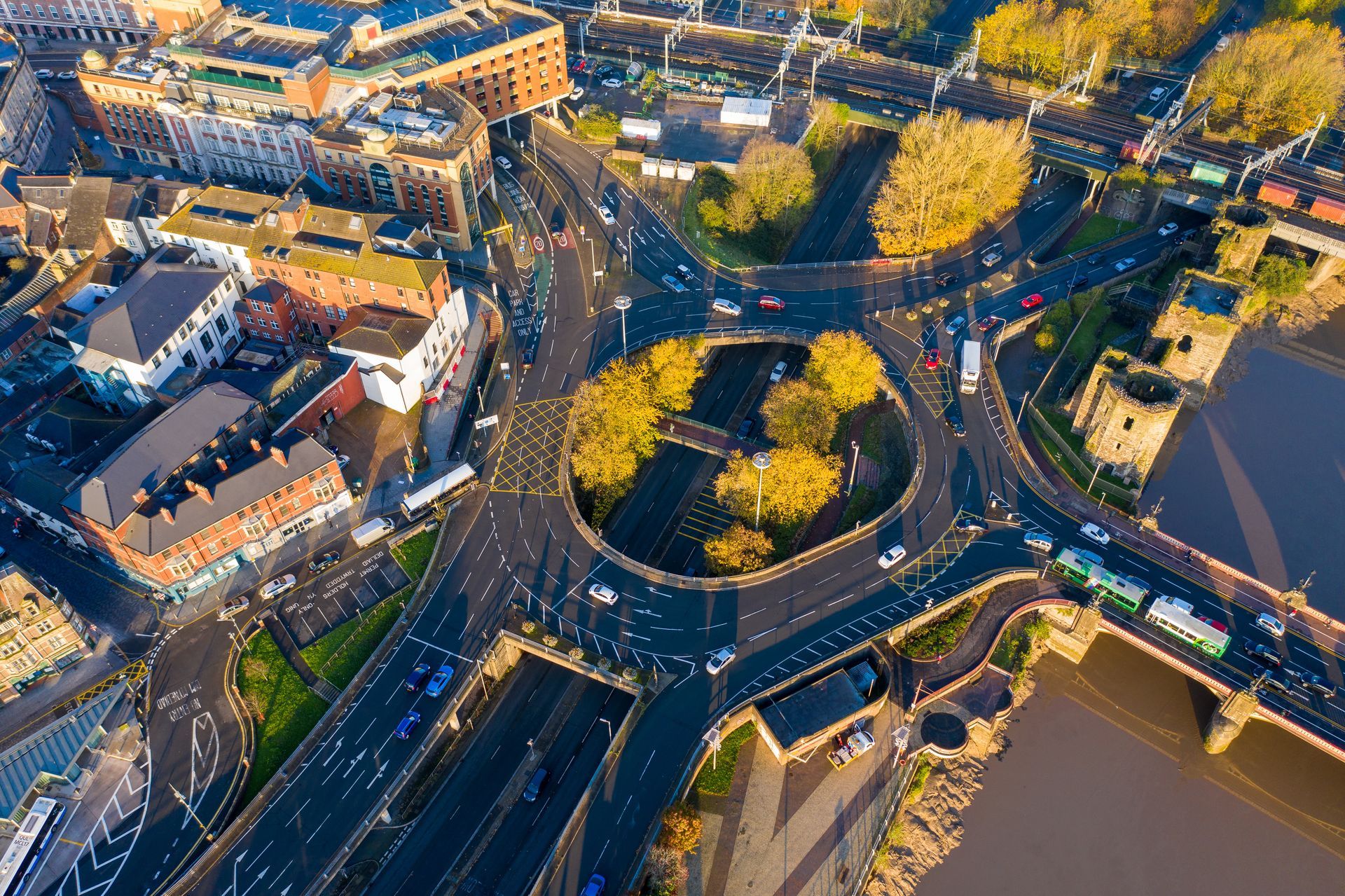 Aerial view of The Old Green Roundabout, Newport, Wales, United Kingdom. The image shows the electric main railway line in the top section and the old 'King's Head Hotel' just off the roundabout. Buses and vehicles are exiting Upper Dock Street onto the roundabout.