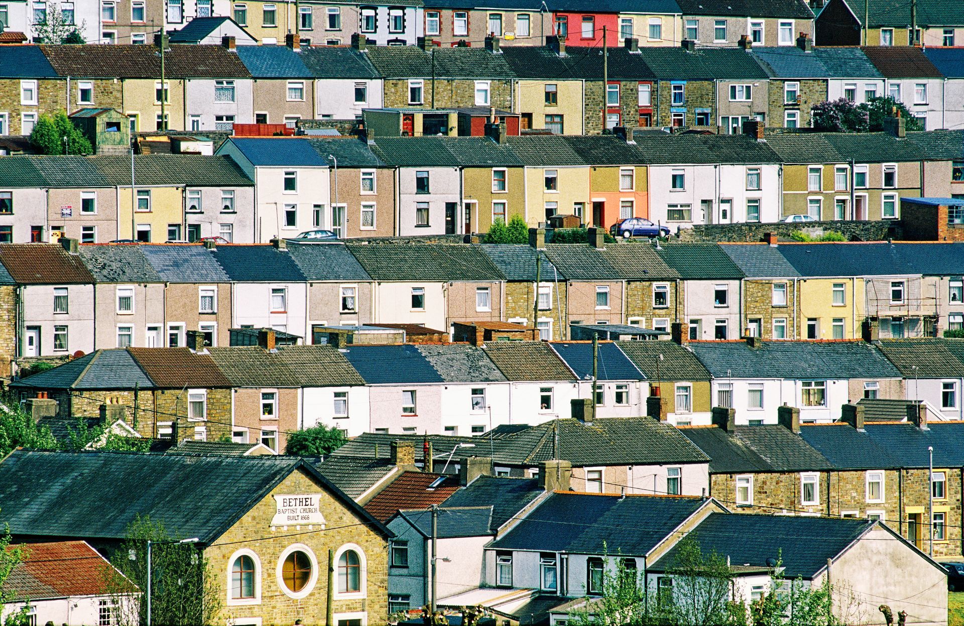 Aerial view of coloured terraced houses in Blaenavon, Wales, United Kingdom with the Bethel Baptist Church built in 1866 in the foreground.