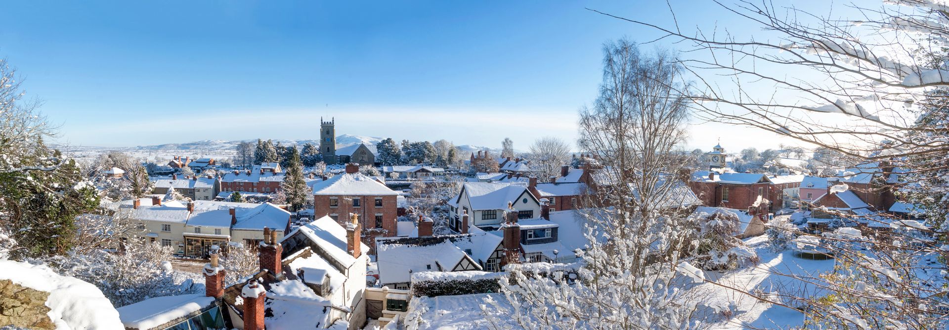 Snowy scene over Montgomery, Powys, Wales, looking towards the Shropshire border with England. The snow and poor weather in Wales can often test the effectiveness of guttering systems. The Guttering Company solve those problems - permanently!
