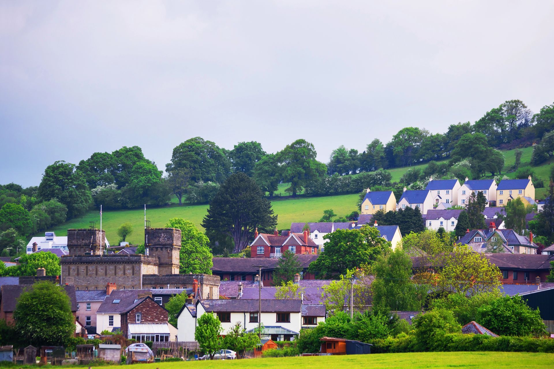 View of community in Brecon, Powys, Wales. A mix of modern and traditional house types is shown, with a Victorian Military Castle in the heart of the town. 