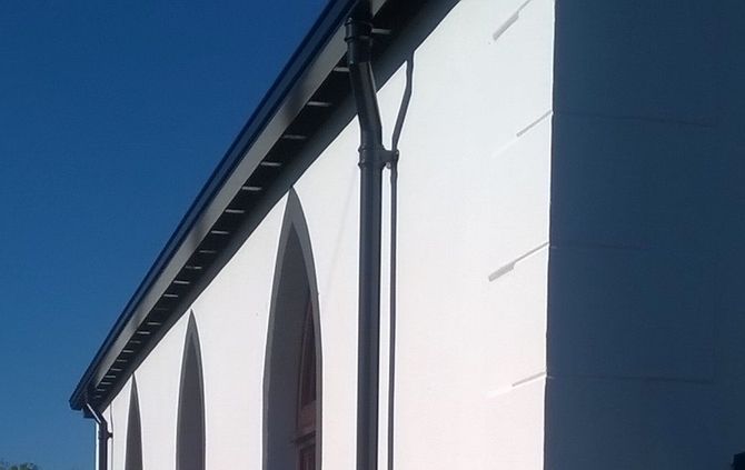 an image of white aluminium gutter system and white soffits and fascia on a modern architect designed house.