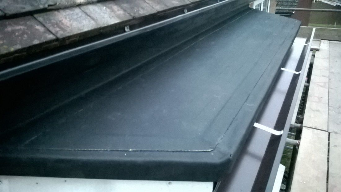 a seamless aluminium guttering system on a modern wooden cricket pavilion in the English countryside.