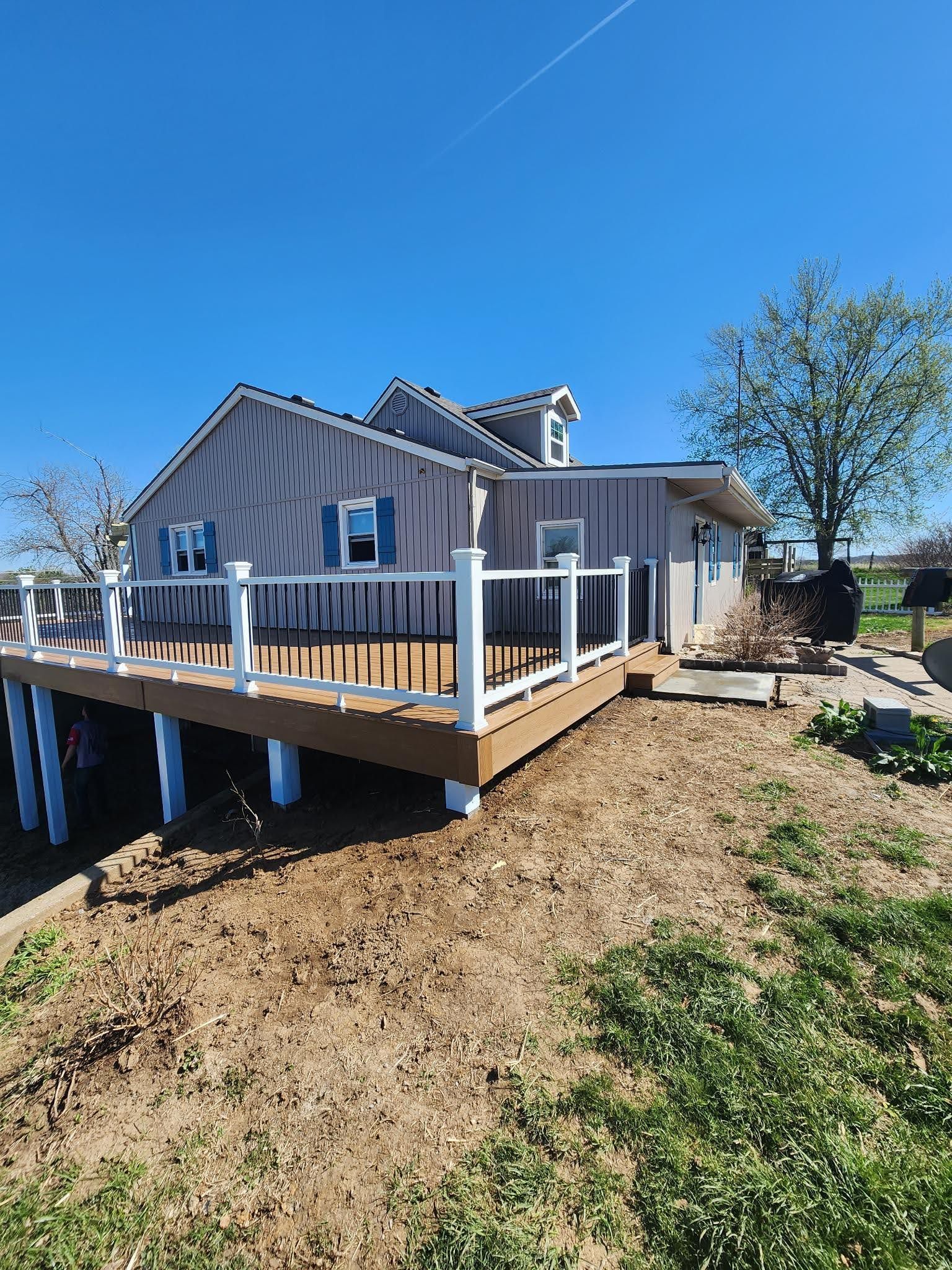 A house with a large deck in front of it.