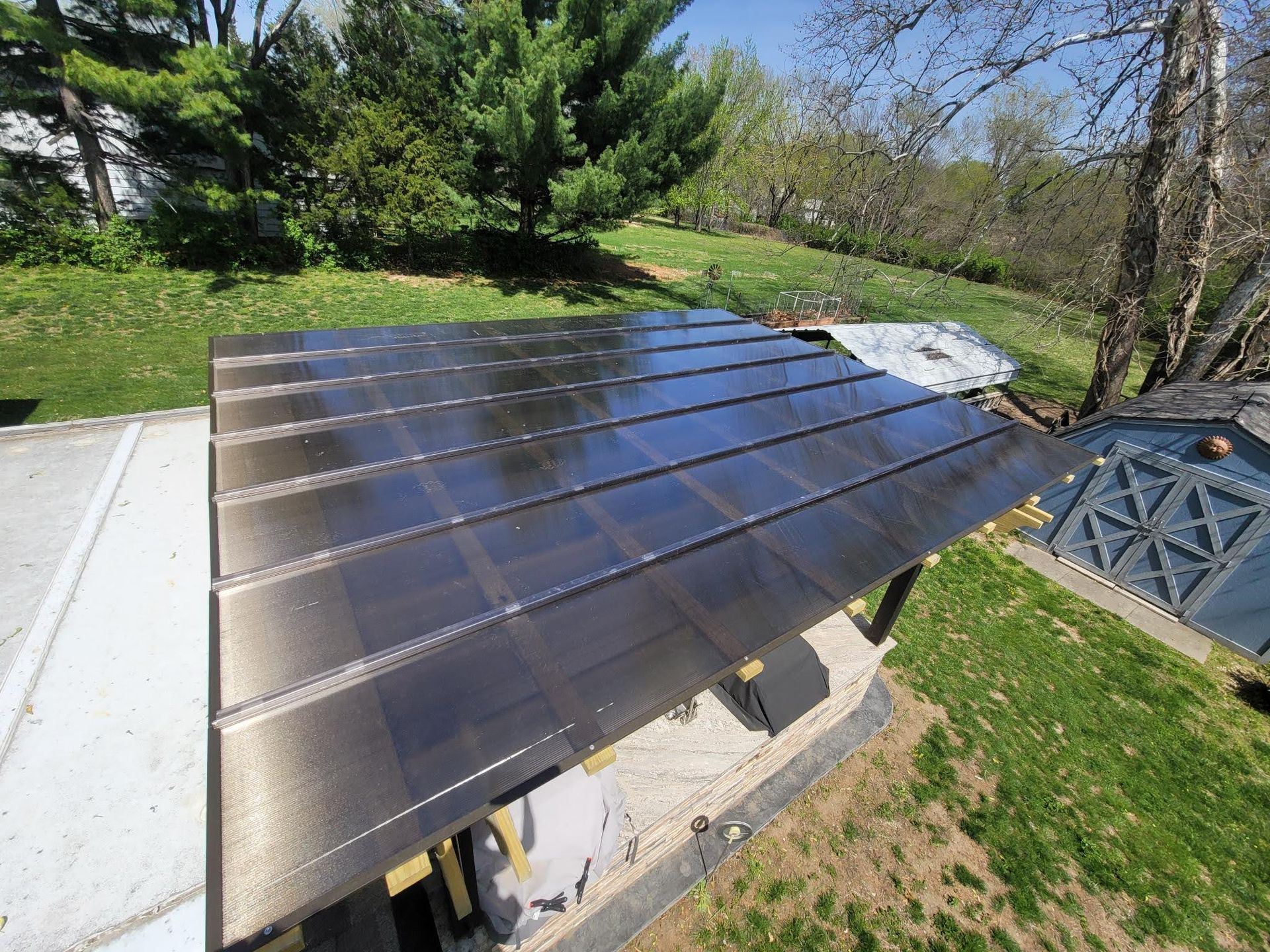 An aerial view of a roof with a lot of solar panels on it.