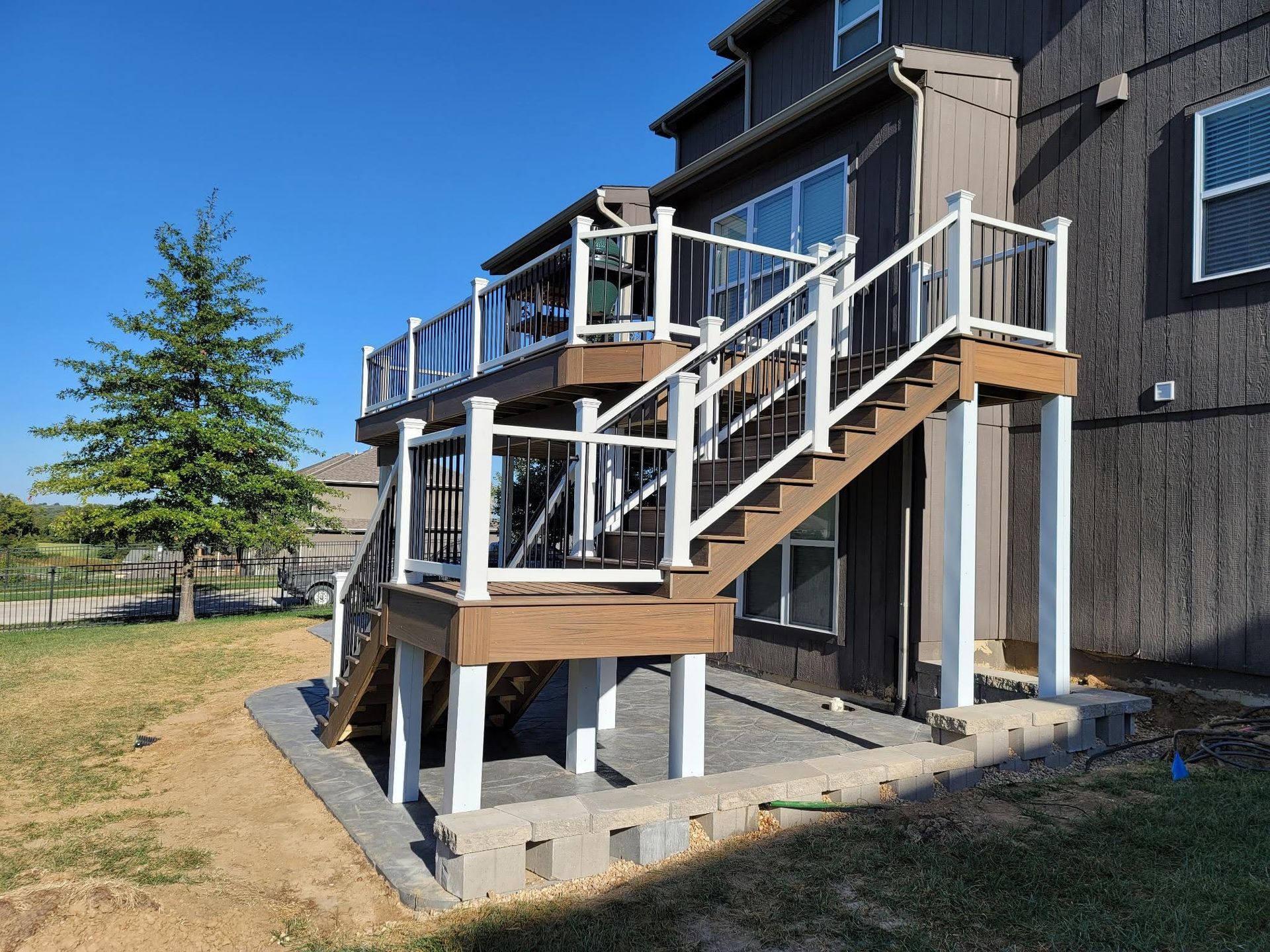 A house with a deck and stairs leading up to it