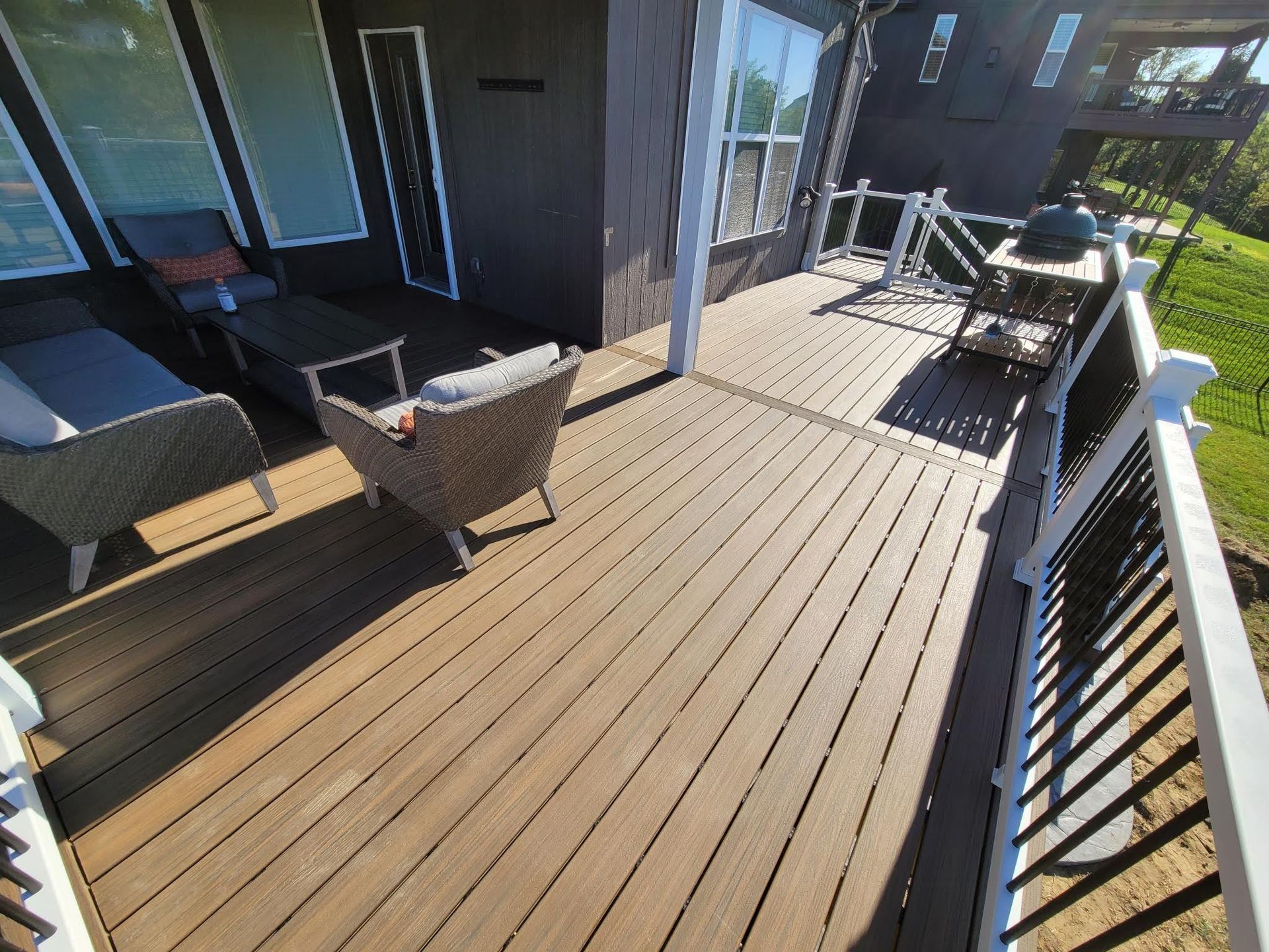 A wooden deck with chairs and a table on it.