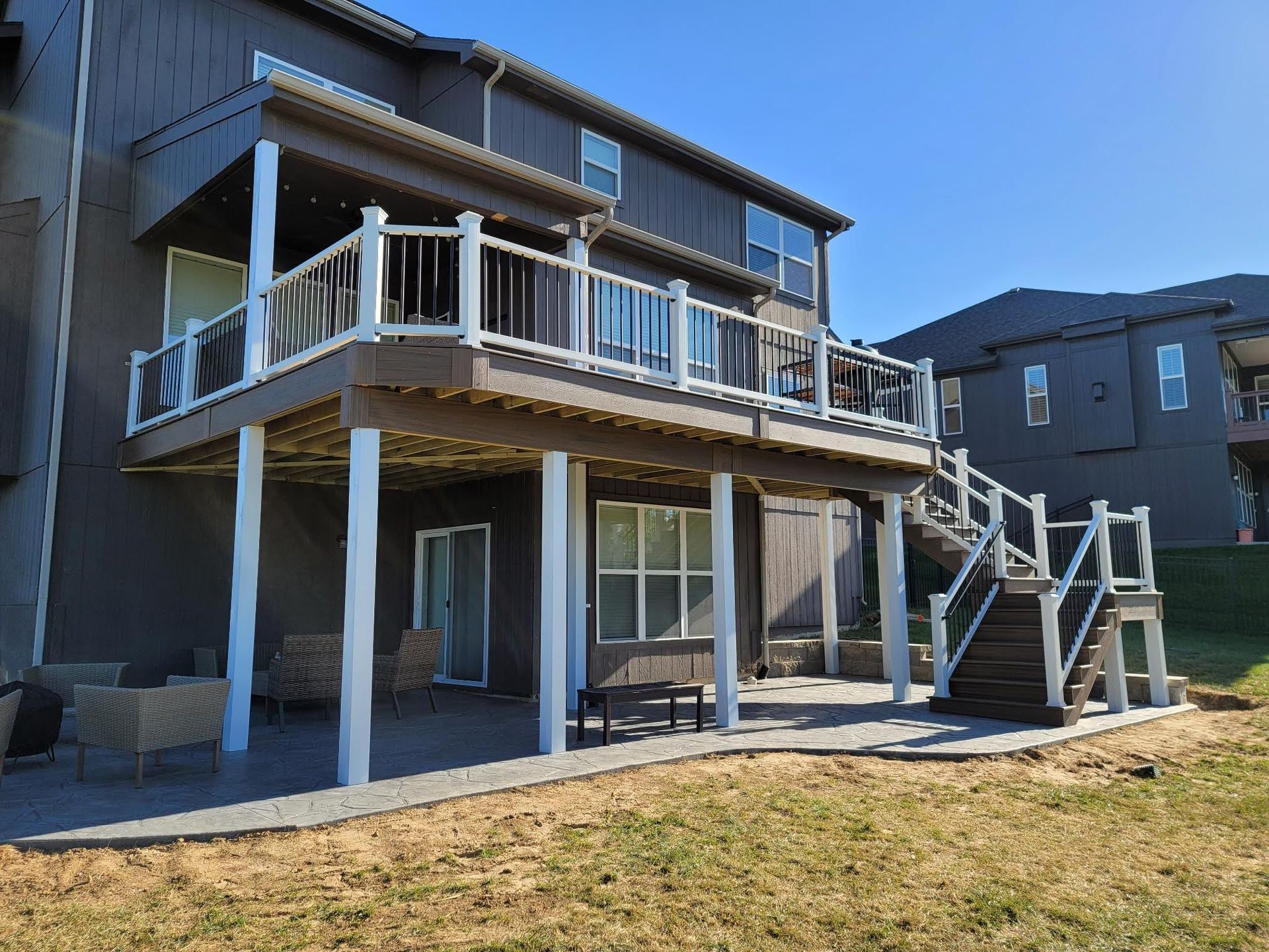 A large house with a large deck and stairs.