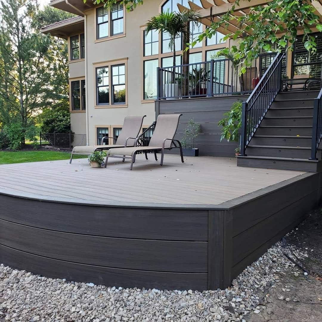 A large house with a deck and stairs in front of it