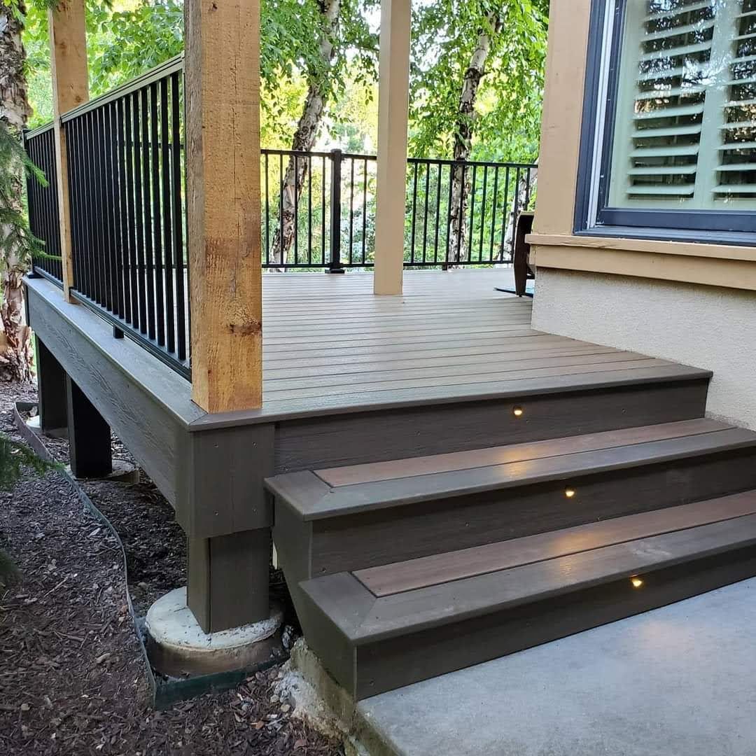 A deck with stairs leading up to it and a railing.