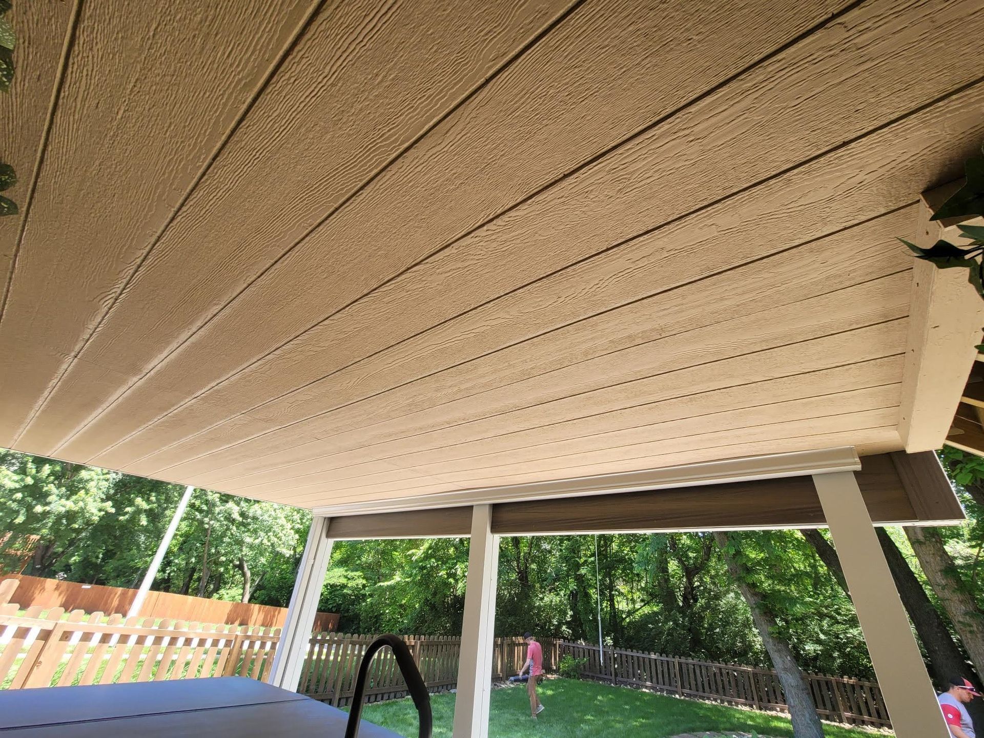 The ceiling of a covered patio with a hot tub underneath it.