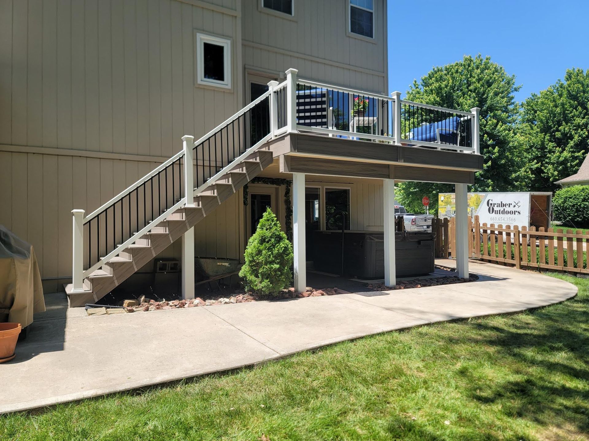 A house with a deck and stairs leading up to it.