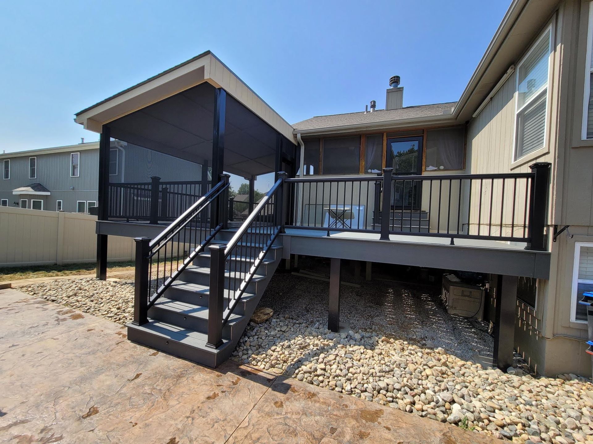 A house with a screened in deck and stairs