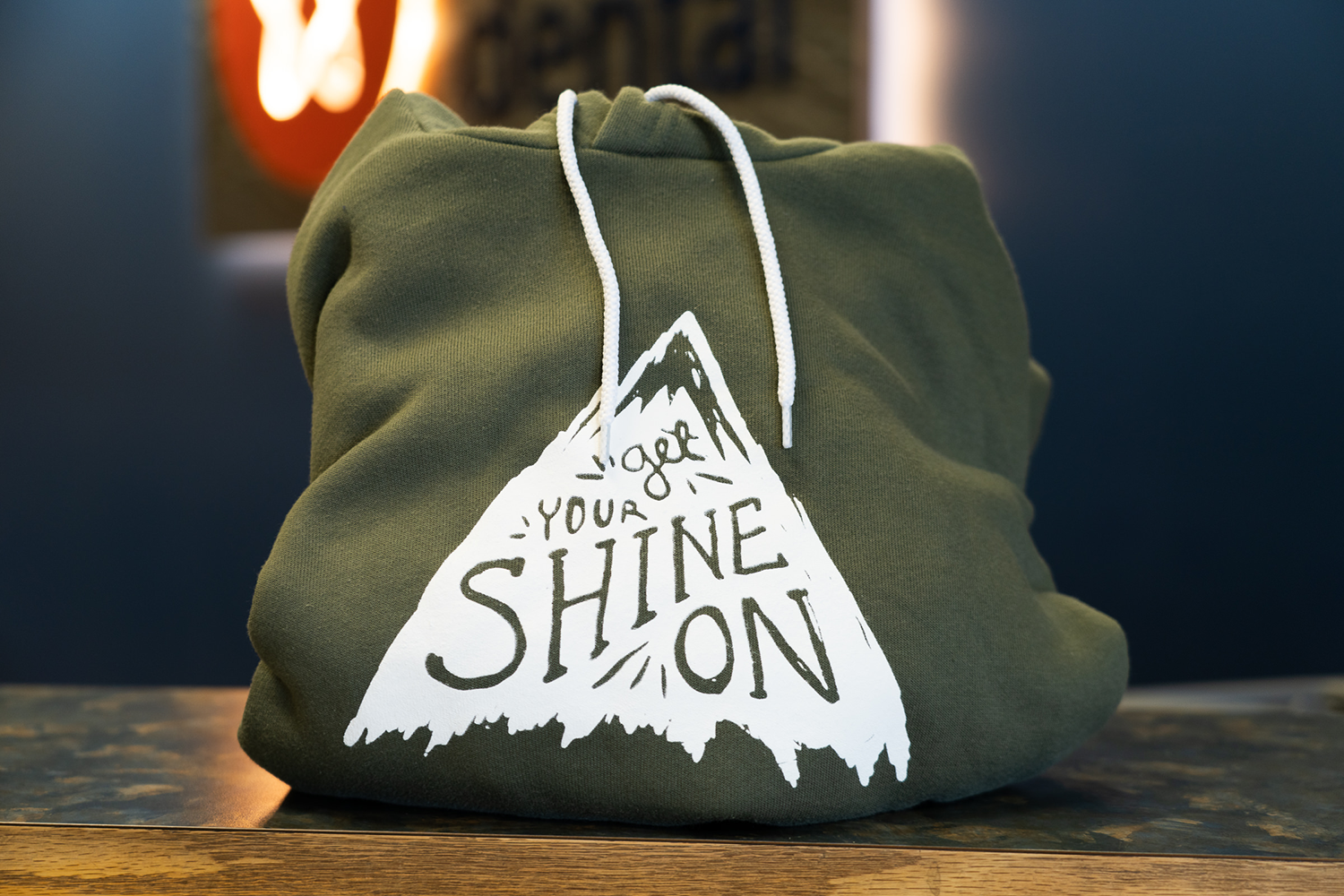 A green hoodie that says shine on on it