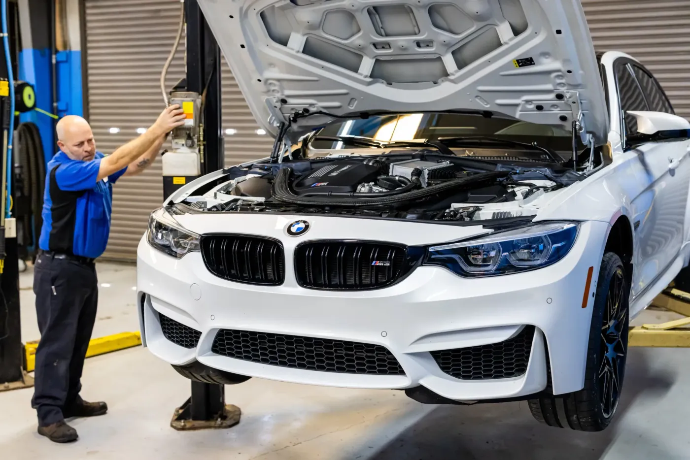 White BMW Vehicle in garage for auto repair | Bavarian Motor Cars