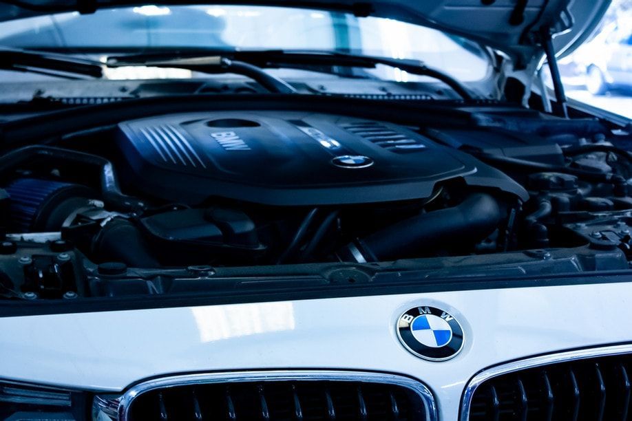 BMW with engine showing, hood open | Bavarian Motor Cars