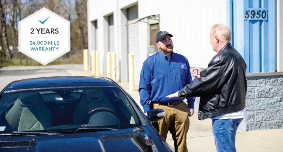Two men are shaking hands in front of a car. | Bavarian Motor Cars