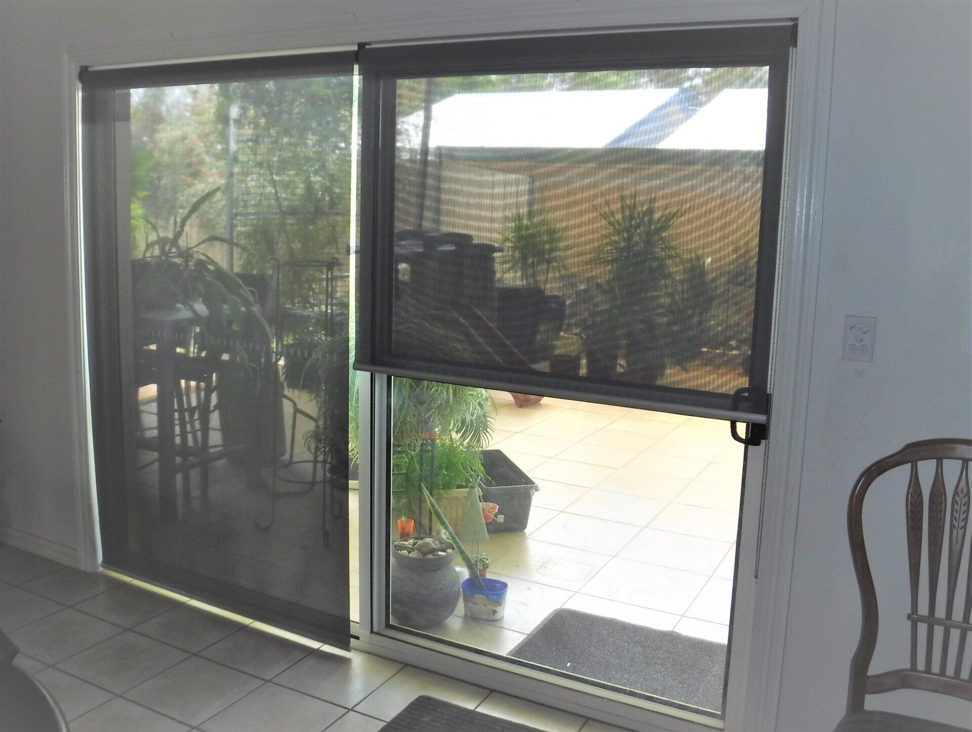 Roller Blind Covering The Door — Blinds, Curtains And Shutters In Alice Springs, NT