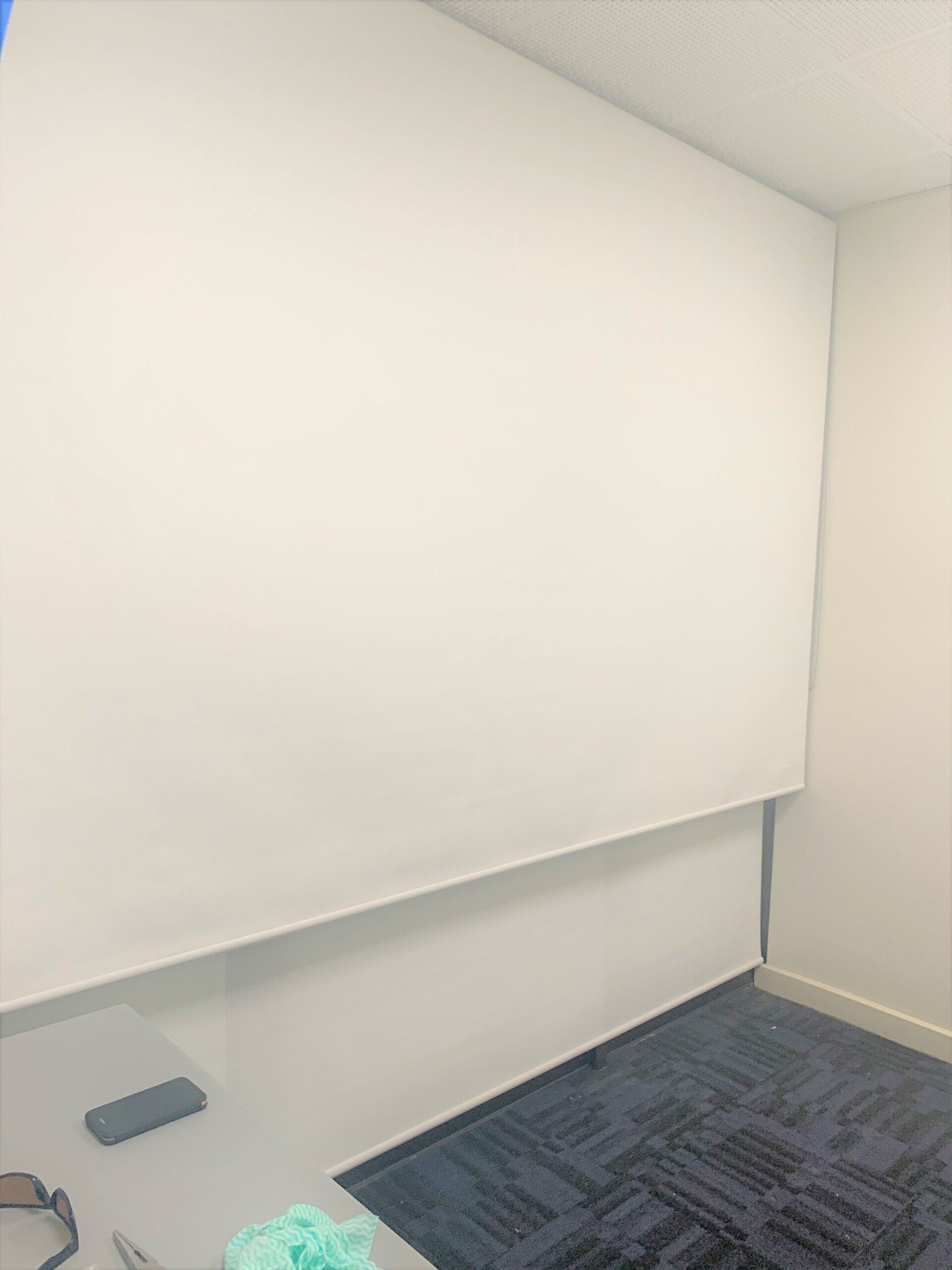 White Roller Shade Inside A Room — Blinds, Curtains And Shutters In Alice Springs, NT