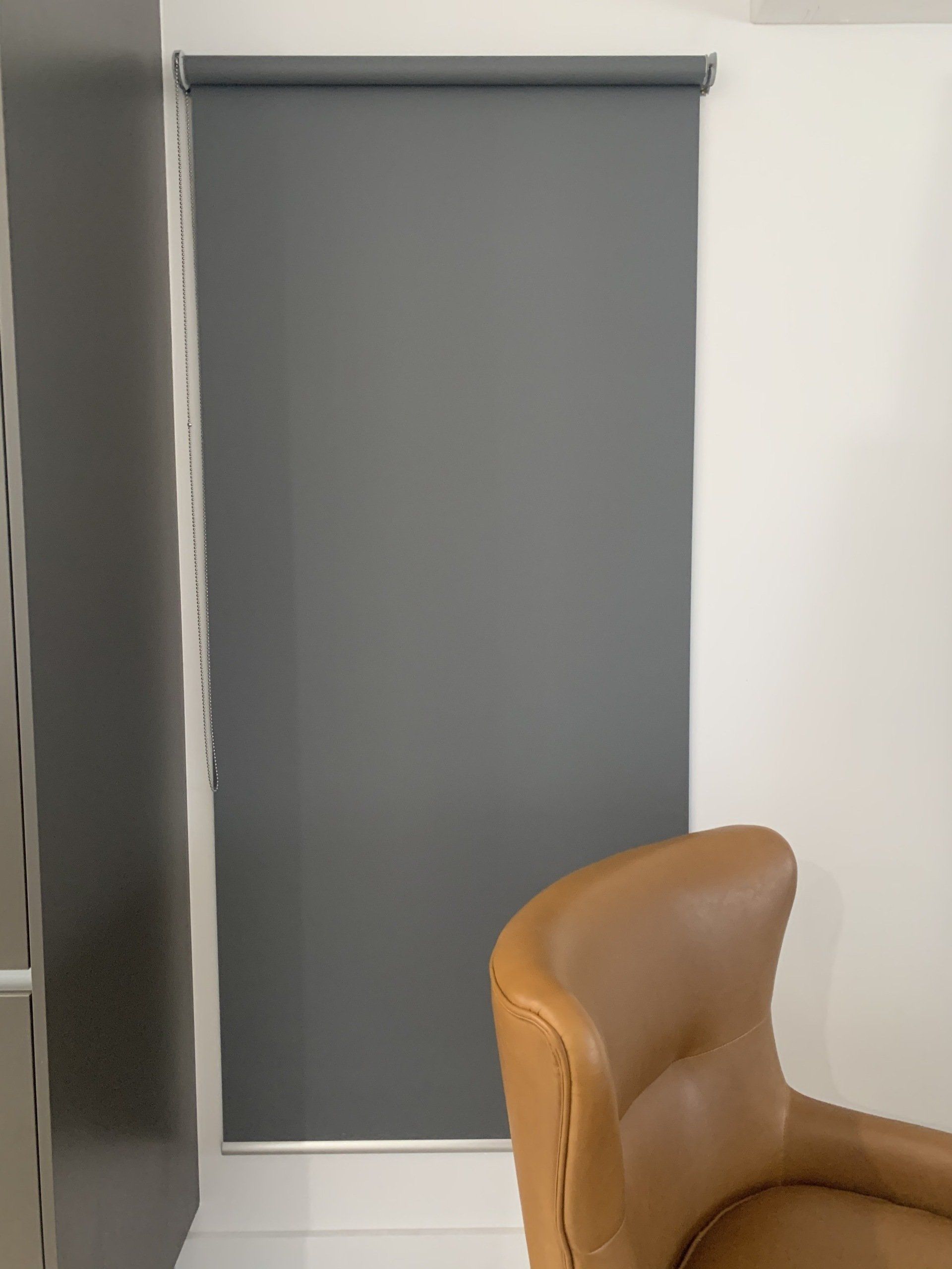 Grey Roller Blinds Behind The Armchair — Blinds, Curtains And Shutters In Alice Springs, NT