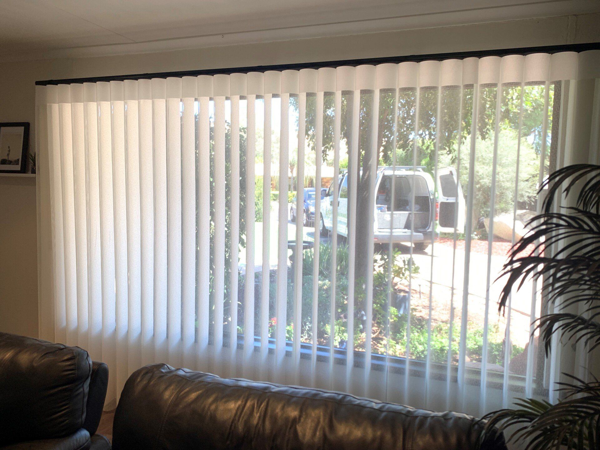 Open White Slatted Shades With Black Couch — Blinds, Curtains And Shutters In Alice Springs, NT