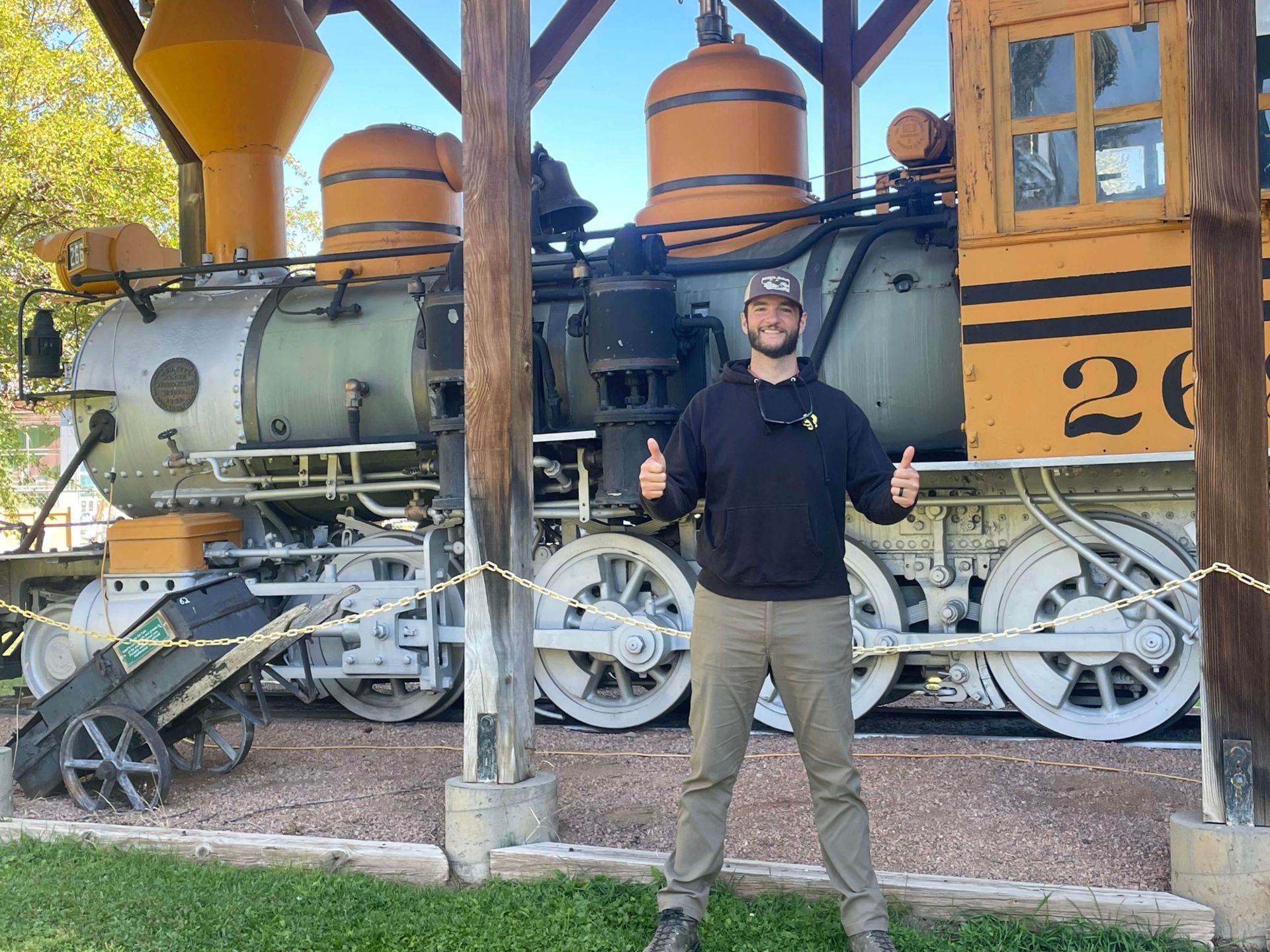 Moosewood Elementary Trail Building and Construction logo: hammer and ax cross, flowers, surrounded by text.