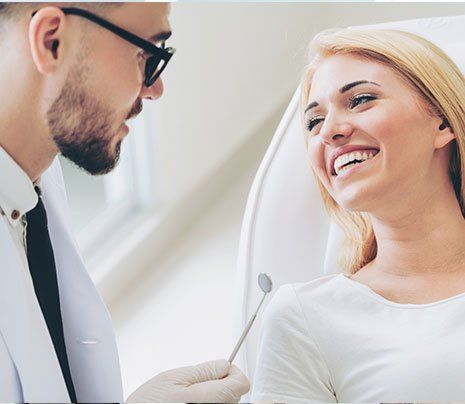 Gum Treatment — Dentist Talking with Patient in Brownsburg, IN
