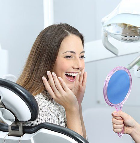 Dentist Office — Woman Checking Her Teeth in Brownsburg, IN
