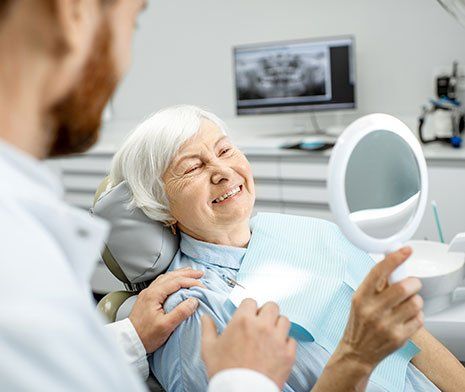 Full Dentures — Senior Woman Checking the Dentures in Brownsburg, IN
