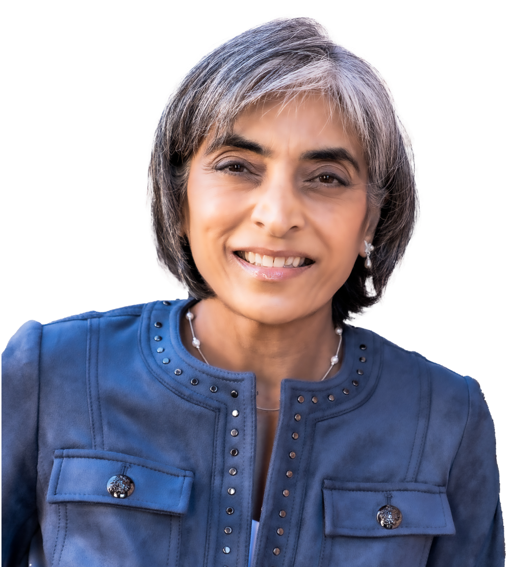 A woman with gray hair is wearing a blue jacket and smiling.