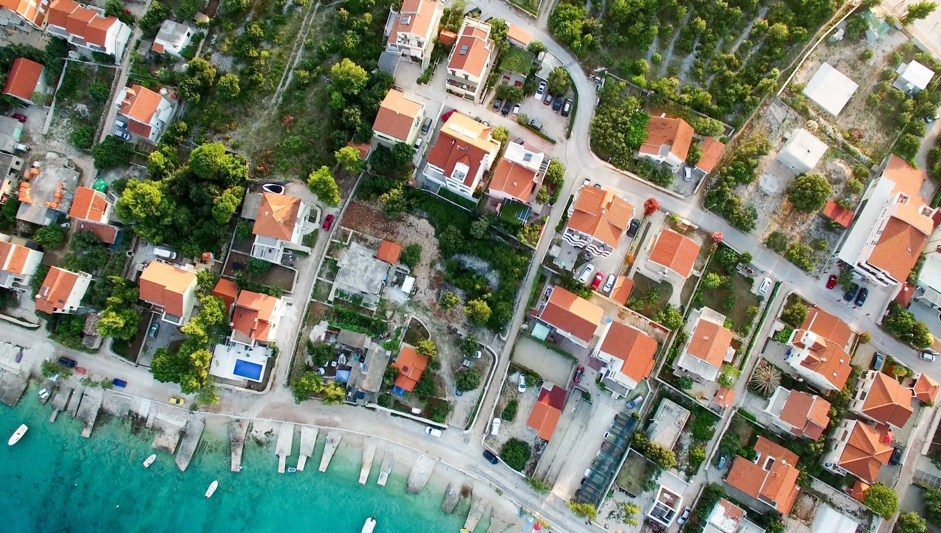 An aerial view of a residential area next to a body of water.