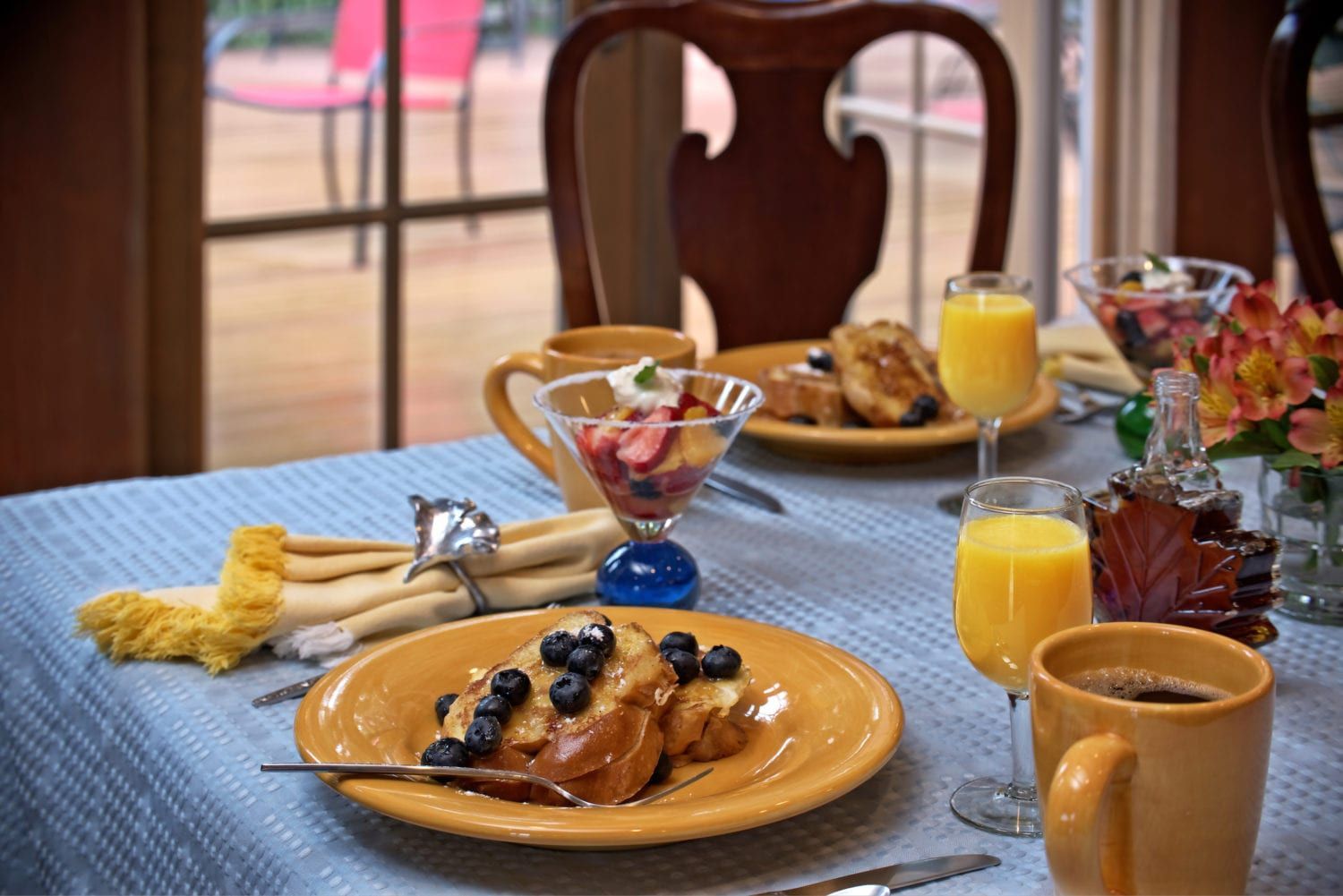 A table topped with plates of food and drinks.
