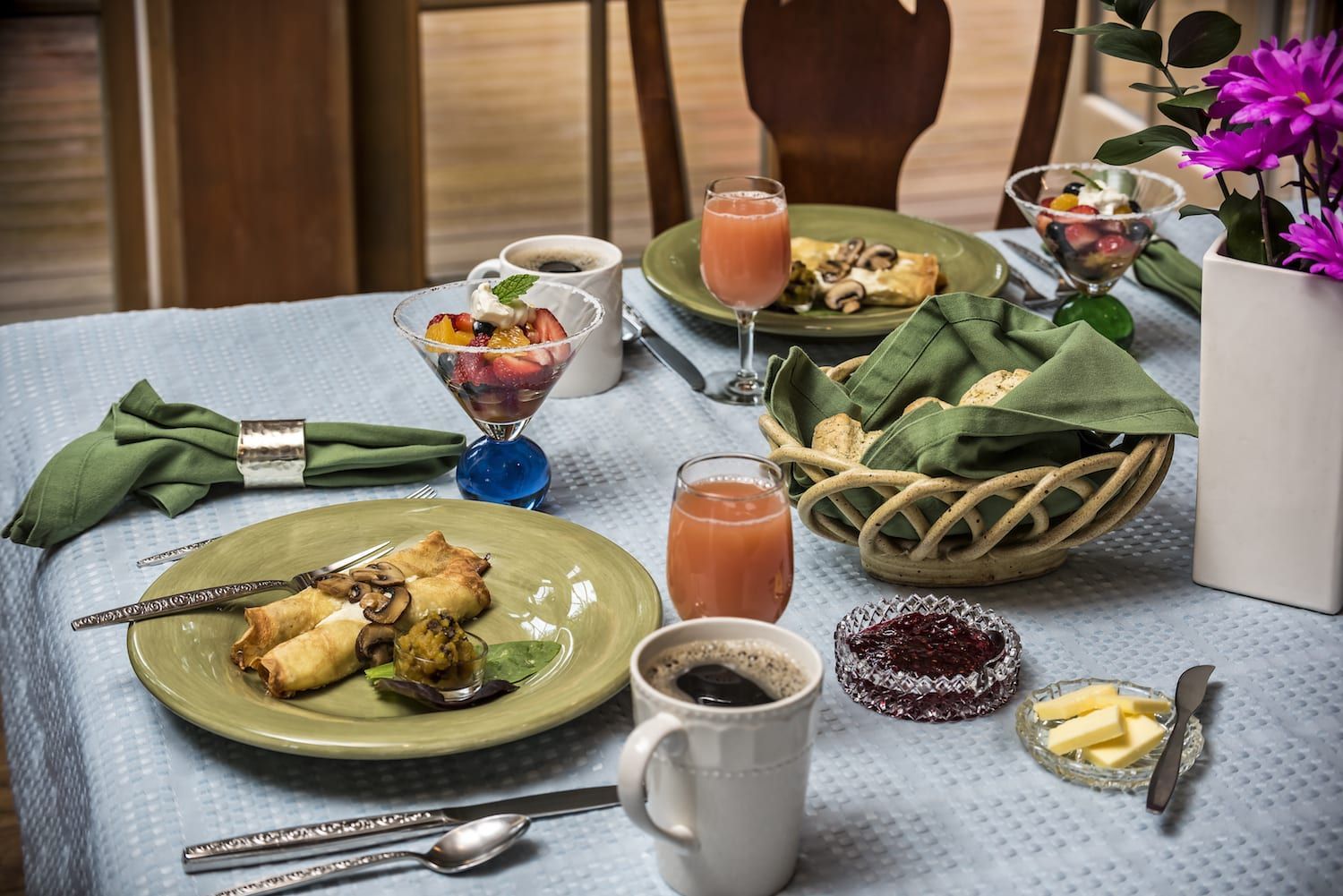 A table topped with plates of food and a cup of coffee.