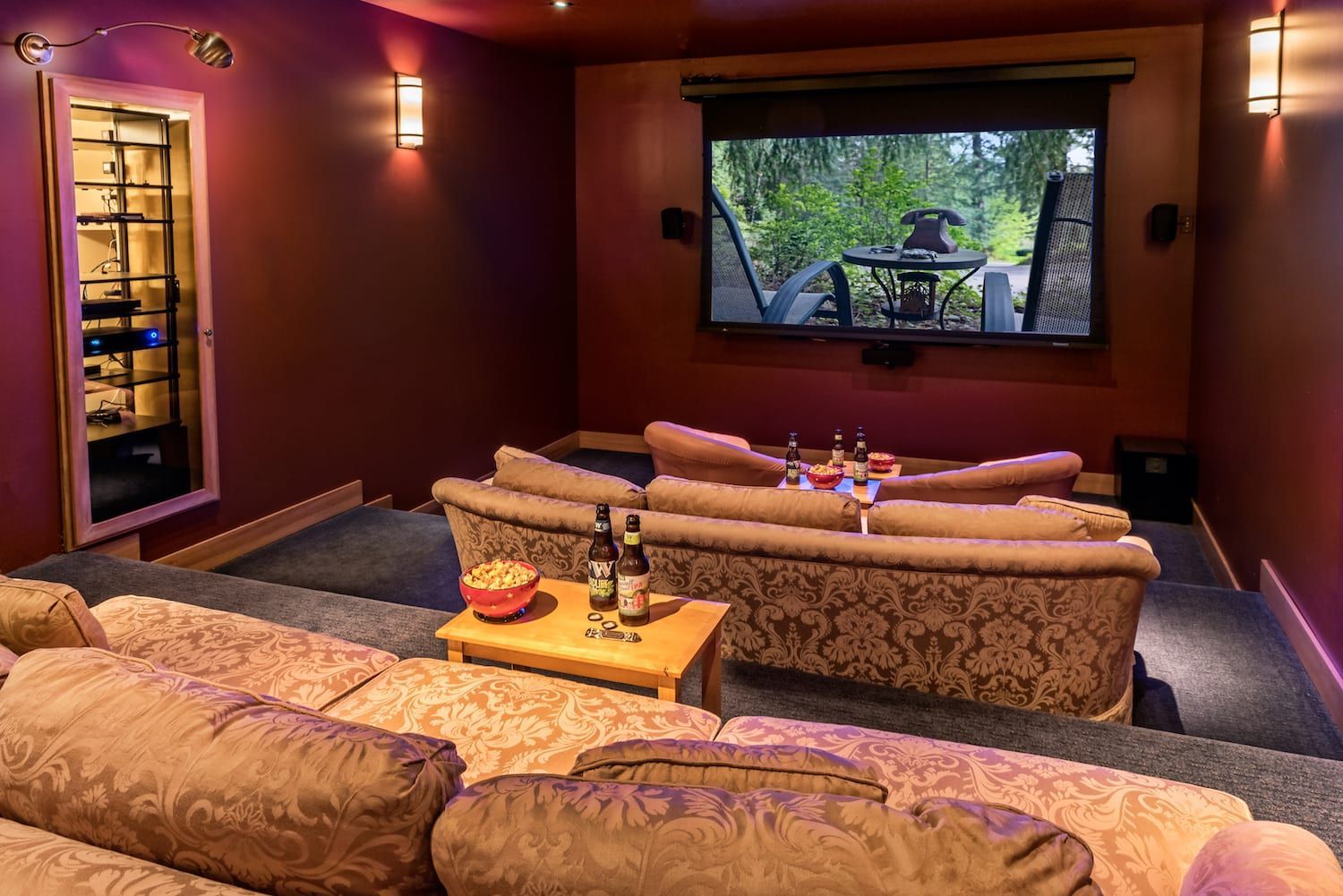 A home theater with a projector screen and a couch