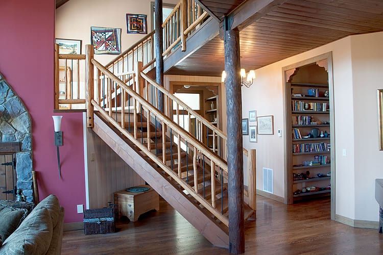 A wooden staircase leading up to the second floor of a house