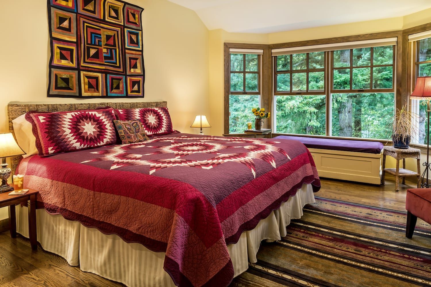 A bedroom with a king size bed and lots of windows