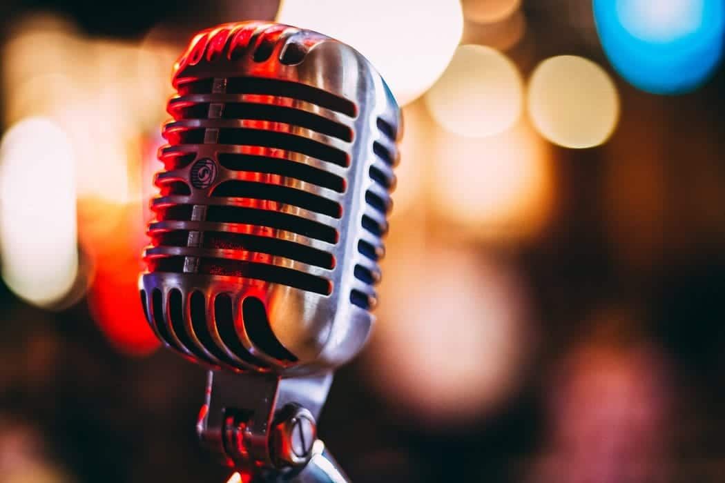 A close up of a microphone with a blurry background.