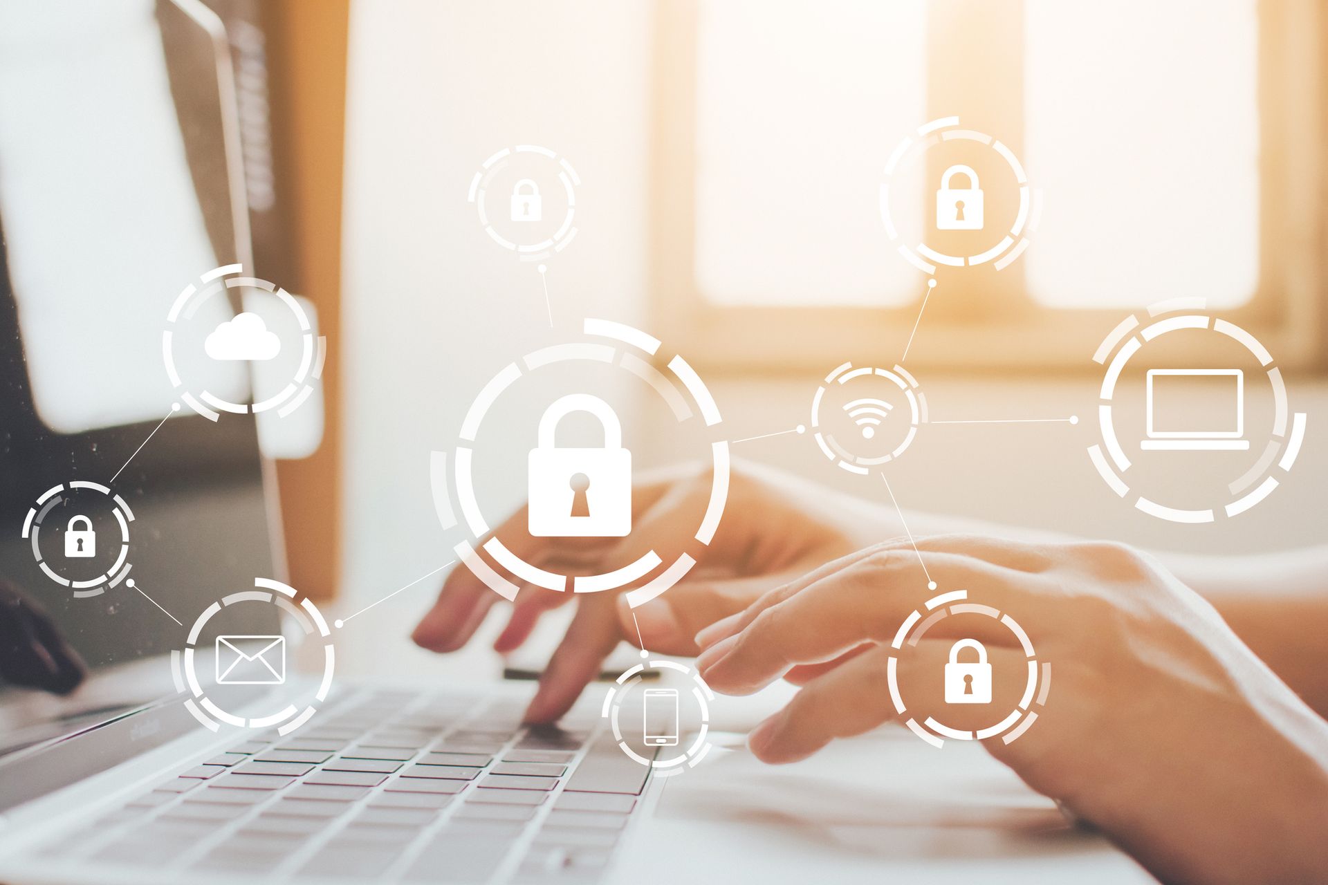 A person is typing on a laptop computer with icons coming out of the screen.