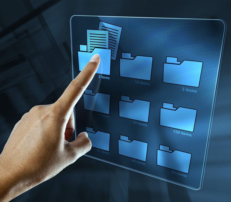 A hand is pointing at a screen with folders on it